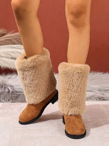 Detail of women's brown faux fur patchwork boots with block heel and round toe.