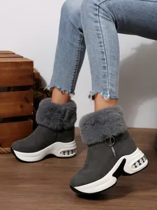 Grey faux fur snow boots with platform sole and side zipper shown on model.