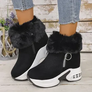 Close-up view of black platform snow boots featuring fluffy faux fur trim detail
