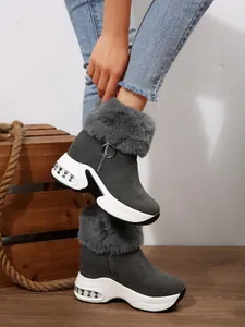 Side detail of gray warm snow boots featuring faux fur trim and thick platform soles