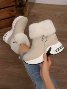 Detailed view of beige winter snow boots with plush fur trim and chunky platform sole