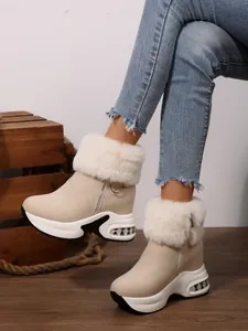 Side view of beige winter snow boots with white faux fur collar and platform sole