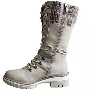 Women's mid-calf winter boots with round toe, knit trim and buckle detail.
