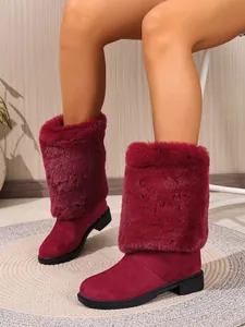 Close-up of wine red faux fur high-top boots with chunky heels and round toes.