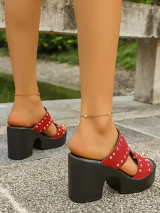 Red studded platform sandals with high block heels for a stylish outdoor summer look