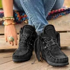 Detailed view of black suede fringe ankle boots featuring western style and moccasin stitching