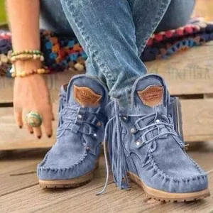 Close-up of blue fringe western ankle boots with moccasin stitching details