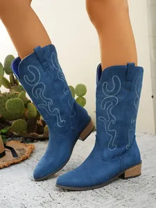 Detailed view of blue suede pointed toe cowboy boots with elegant embroidery