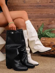 Detailed view of slouchy gaiter boots in black and white with a chic thick heel design.