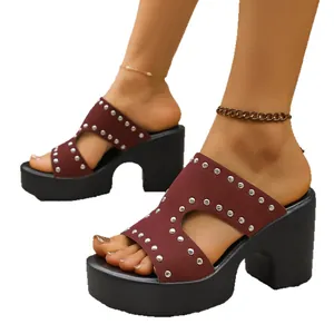 Burgundy rivet platform slide sandals with chunky high heels and open-toe design.