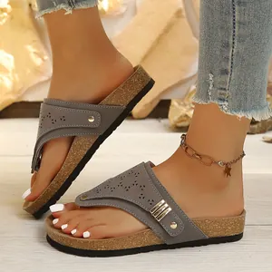 Vintage gray women's flat thong sandals with cork sole and laser-cut details.