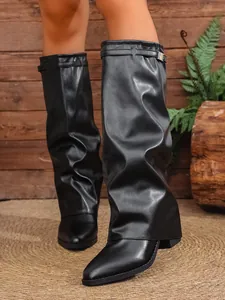 Black pleated gaiter boots with chunky heels in a stylish British fashion aesthetic