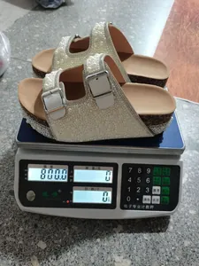 Detail showing weight of pearl and rhinestone-embellished platform cork sandals
