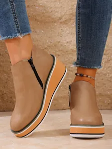 Retro Damen Keilstiefeletten in Braun mit gestreifter Plateausohle und Reißverschluss.