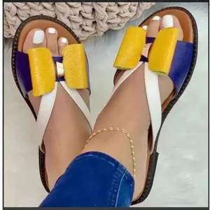 Close-up detail of women's flat beach sandals featuring a vibrant color-blocking bow design
