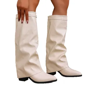 Elegant cream slouchy pant-leg boots with chunky heels and pointed toes for women.
