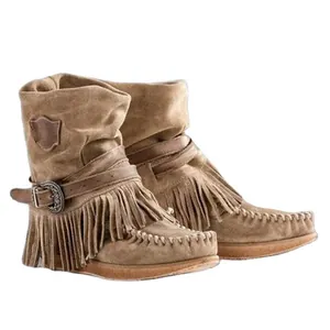 Bohemian tan suede mid-calf boots featuring decorative fringe and belt buckle detail
