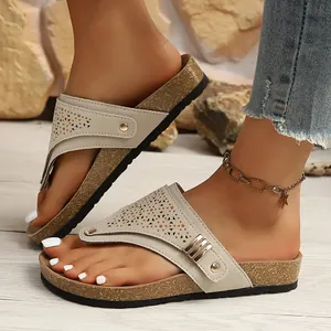 Chic beige women's flat flip-flop sandals with perforated straps and cork-style soles