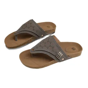 Comfortable women's platform thong sandals with decorative laser-cut straps in brown color.