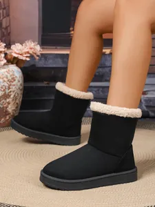 Detail van zwarte pluche sneeuwlaarzen voor dames met voering van imitatiebont voor binnen