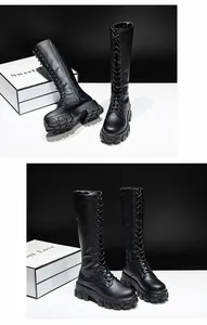 Side view of black platform knee-high lace-up boots with chunky soles
