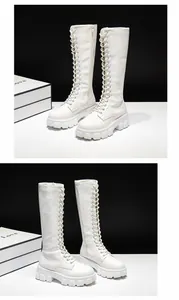 Close-up of white platform lace-up knee-high boots with chunky soles