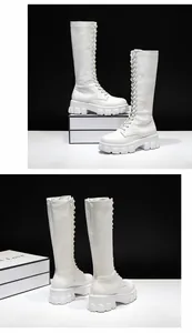 Detailed view of women's white platform lace-up knee-high boots with side zipper closure