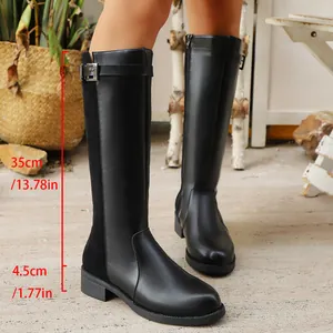 Detail view of black British style tall boots with measurements and side zipper
