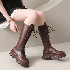Stylish brown lace-up knee-high boots with chunky platform soles and side zipper