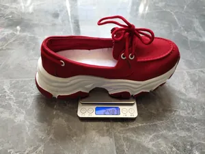Weight detail of a red platform lace-up shoe on a digital scale, 248.3g.