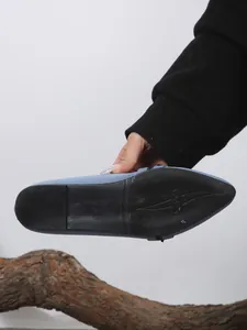 Bottom view of blue fly-knit flats showing the non-slip rubber sole and size marking