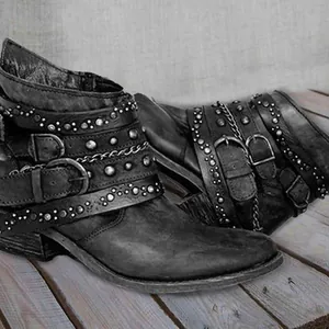 Vintage punk style leather ankle boots with multi-buckle straps, rivets and chains.