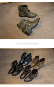 Detailed view of women's biker boots featuring metallic studs, buckles, and chains.