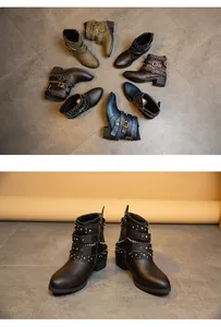 Detailed view of women's chunky heel Martin boots with studded buckles and chains.