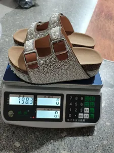 Detailed weight measurement showing pearl and rhinestone double-buckle cork sandals