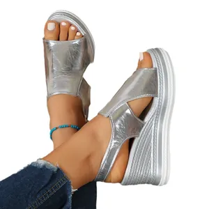 Shiny silver wedge sandals for women featuring a peep-toe and cutout platform design.