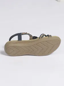Detailed macro view of Bohemian flat sandal showing non-slip sole and braided straps.