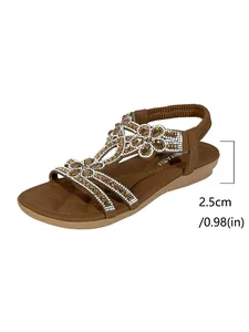 Detail view showing the 2.5cm heel height of these brown rhinestone flat sandals.