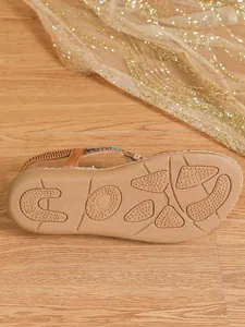 Detailed macro view of the non-slip textured tan sole on a Bohemian flat beach sandal