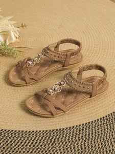 Bohemian brown flat sandals with beaded floral accents and elastic ankle strap detail