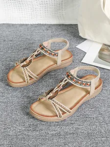 Detail view of Bohemian flat sandals featuring ethnic embroidery and wood beads