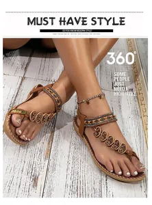 Close-up of beaded heart-shaped patterns on Bohemian flat sandals worn on a wood surface.