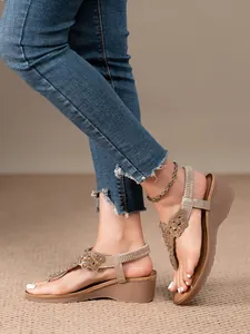 Close-up detail of bohemian wedge sandals with hand-beaded rhinestones and elastic heel