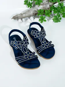 Detail shot of navy blue Bohemian flat sandals with floral blue rhinestone decorations