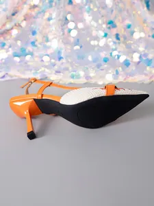 Detail of orange slingback high heel sandal with patterned pointed toe and slim heel