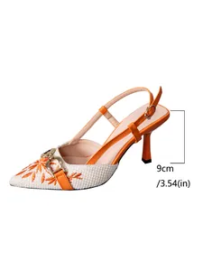 Detailed view of the 9cm stiletto heel on orange embroidered slingback sandals for women