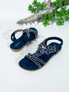 Detail of women's navy blue flat sandals with bohemian rhinestone floral design