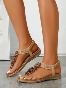Close-up detail of Bohemian style flat sandals with colorful beads and tassels decoration