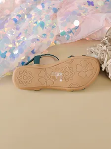 Detailed view of the flower-patterned anti-slip sole of these Bohemian flat sandals.