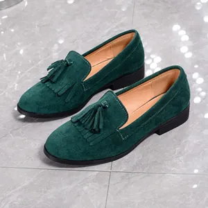 Elegant dark green vintage suede loafers for women featuring decorative tassels and round toe.